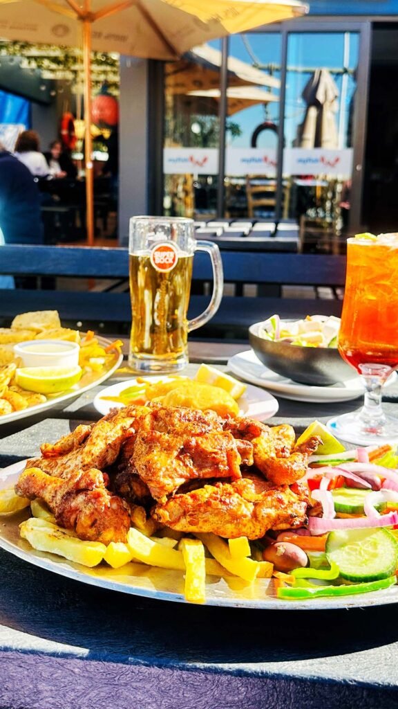 Flame-grilled Portuguese peri-peri chicken served with a side salad.