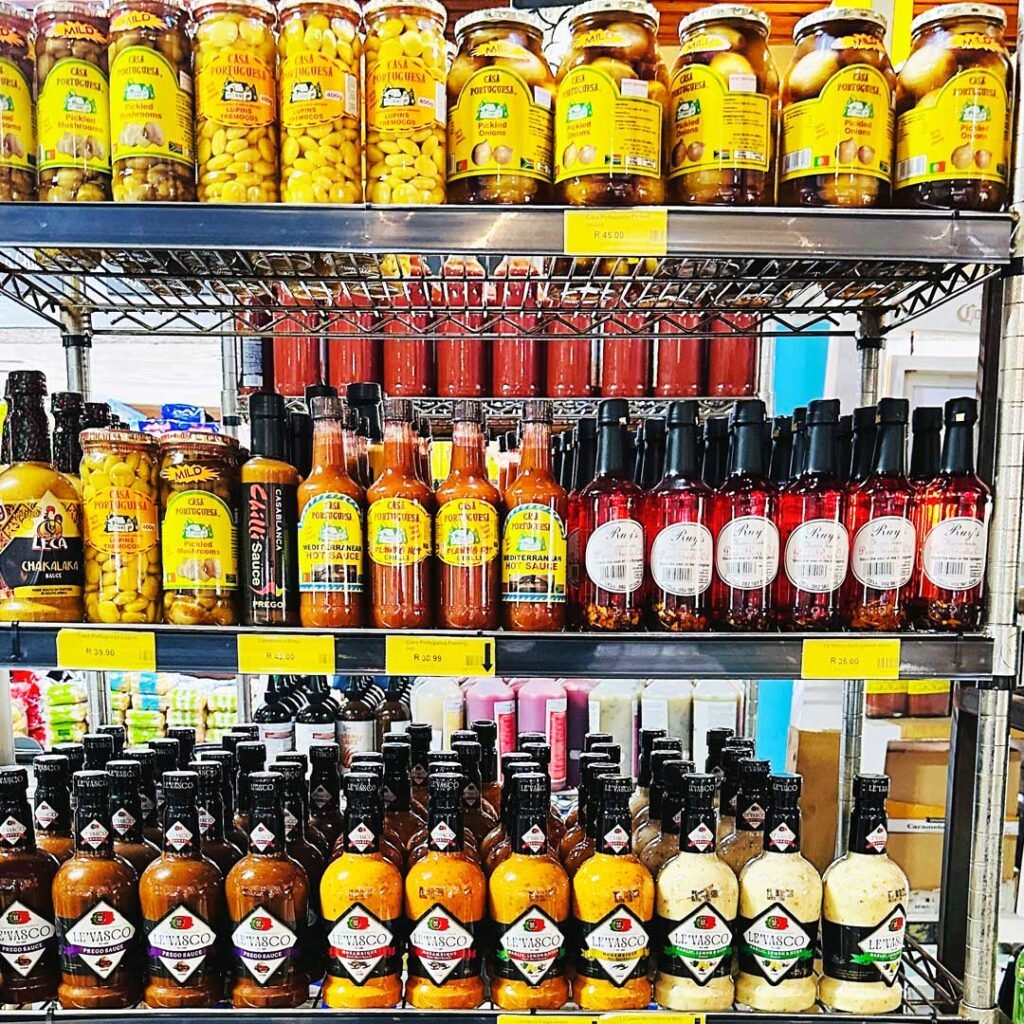 Shelves stocked with imported olive oils and spices at the MyFish grocery store.