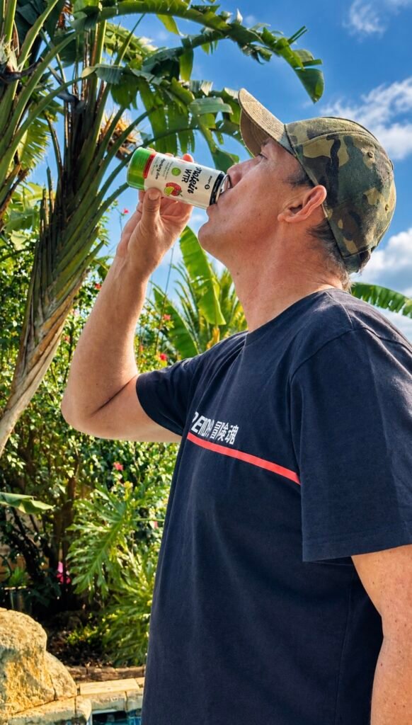 Judd drinking a Sport Rx Protein WTR can outdoors in the sun