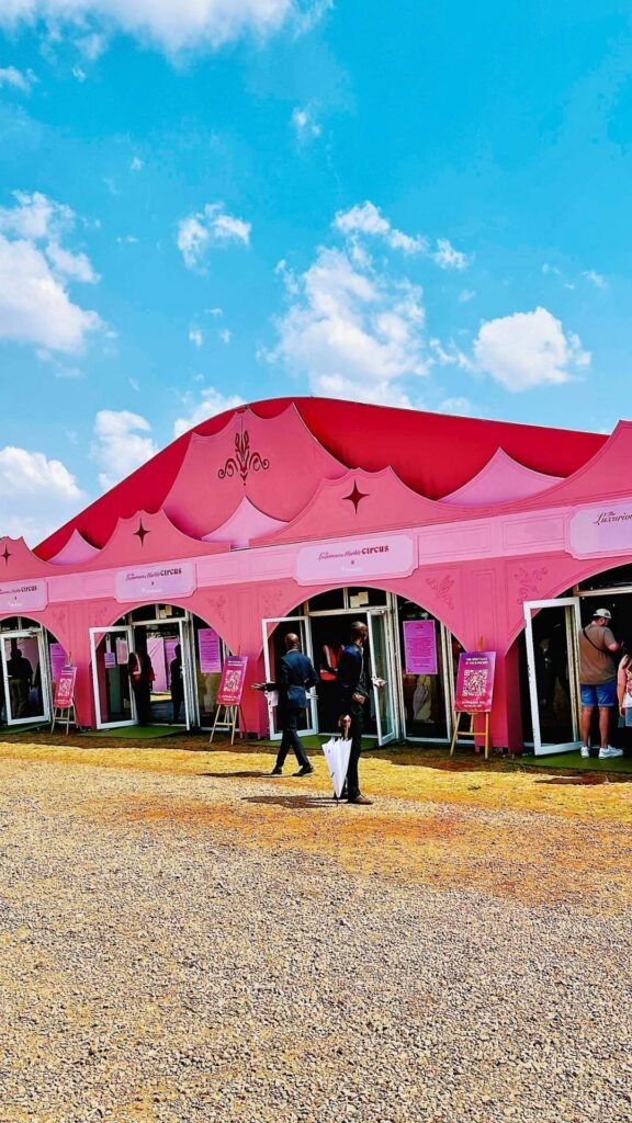 Guests entering the grand, pink-tented main pavilion and entrance structure at the Luxurious Marble Circus event in Muldersdrift.