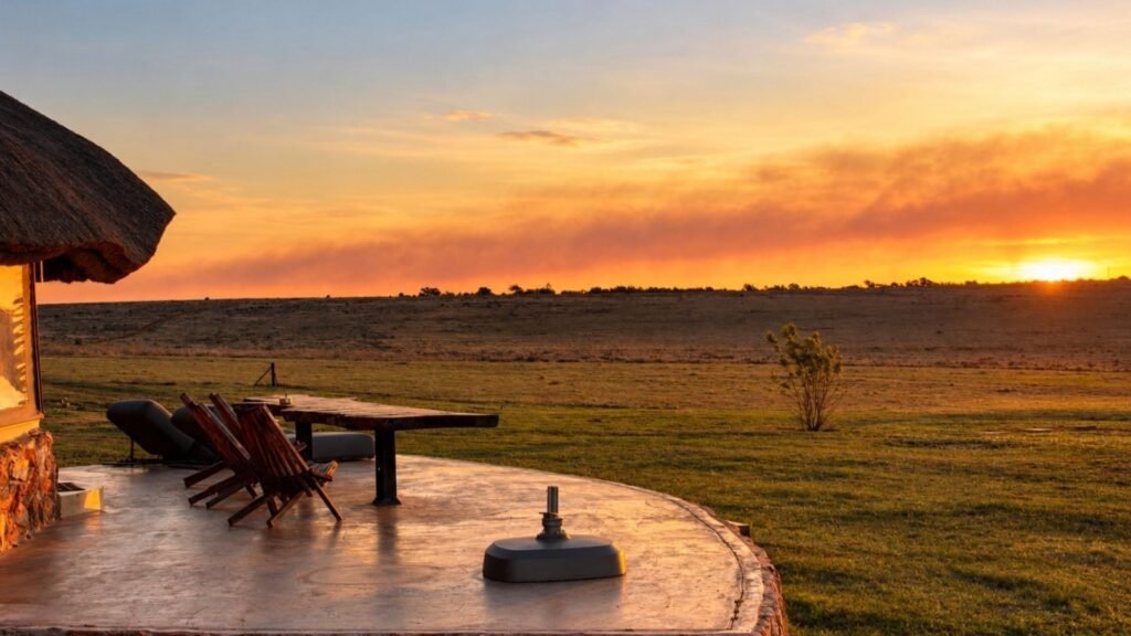 Golden sunset over the Magaliesberg bushveld viewed from the private deck of Sibani Lodge