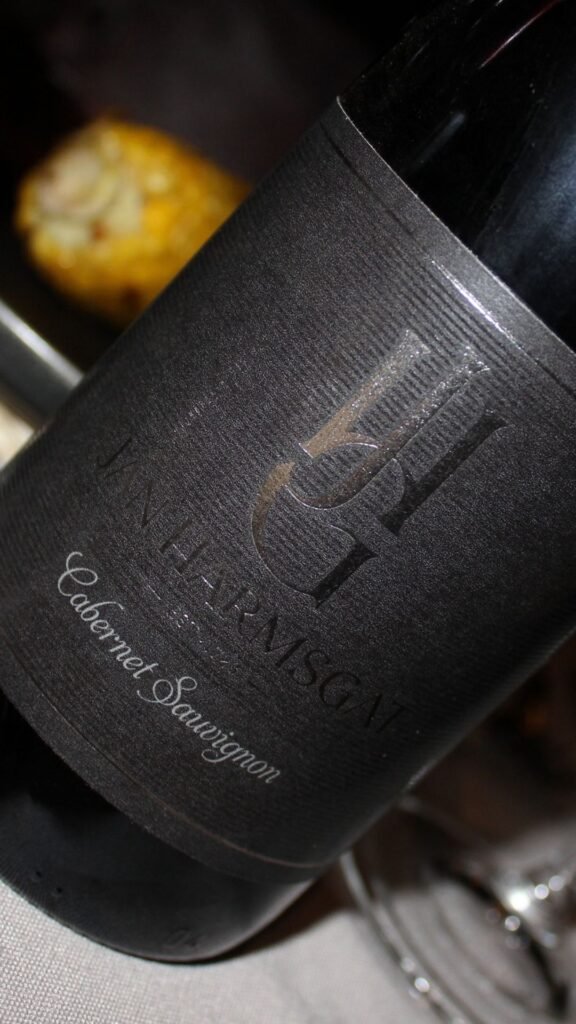 Close-up of Jan Harmsgat Cabernet Sauvignon bottle on the dinner table at Sibani Lodge
