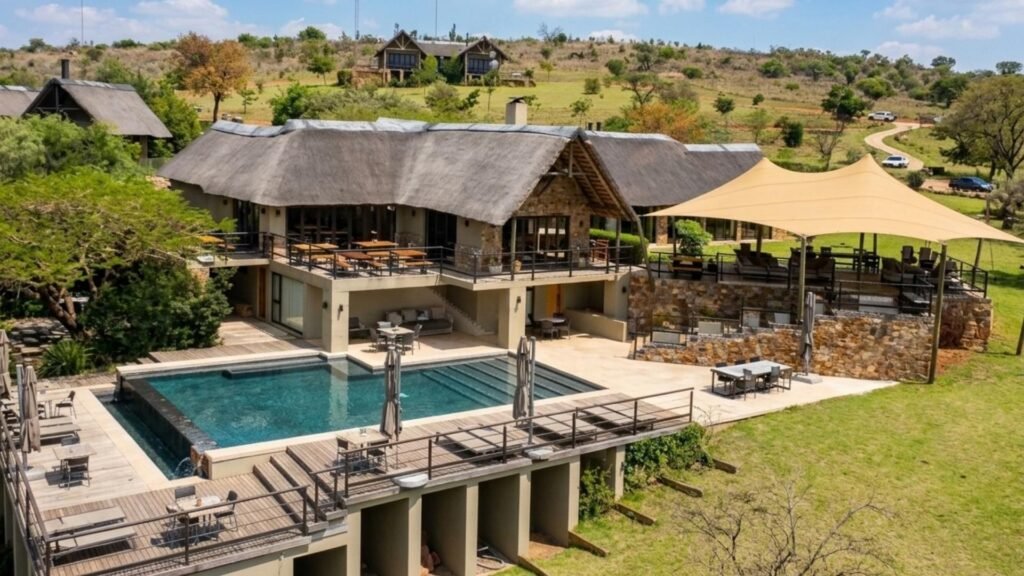 Stunning aerial view of Sibani Lodge main building, infinity pool and surrounding private villas